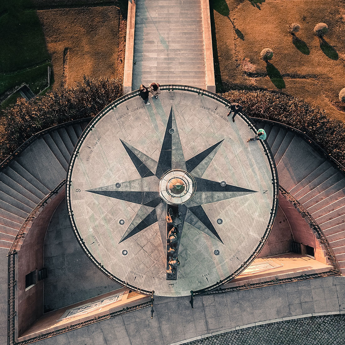 Photo looking down upon an observation deck with a compass design on the ground